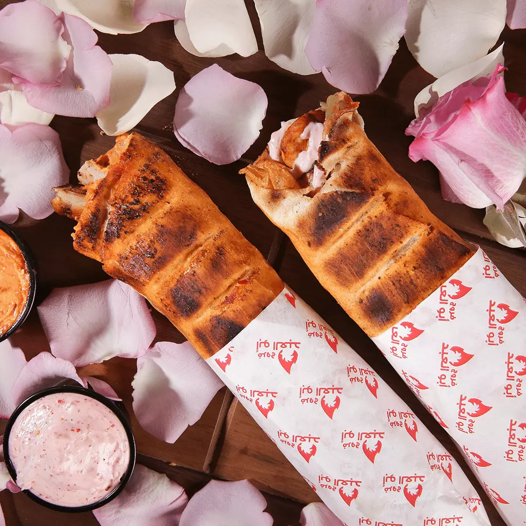 Shawarma sandwiches with flowers and sauce.